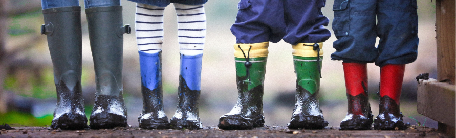 Children's feet in rubber boots
